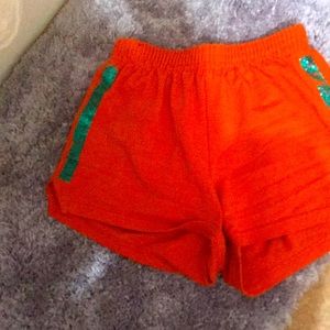 selling shorts it’s made by a famous designer the shorts are orange with stripes